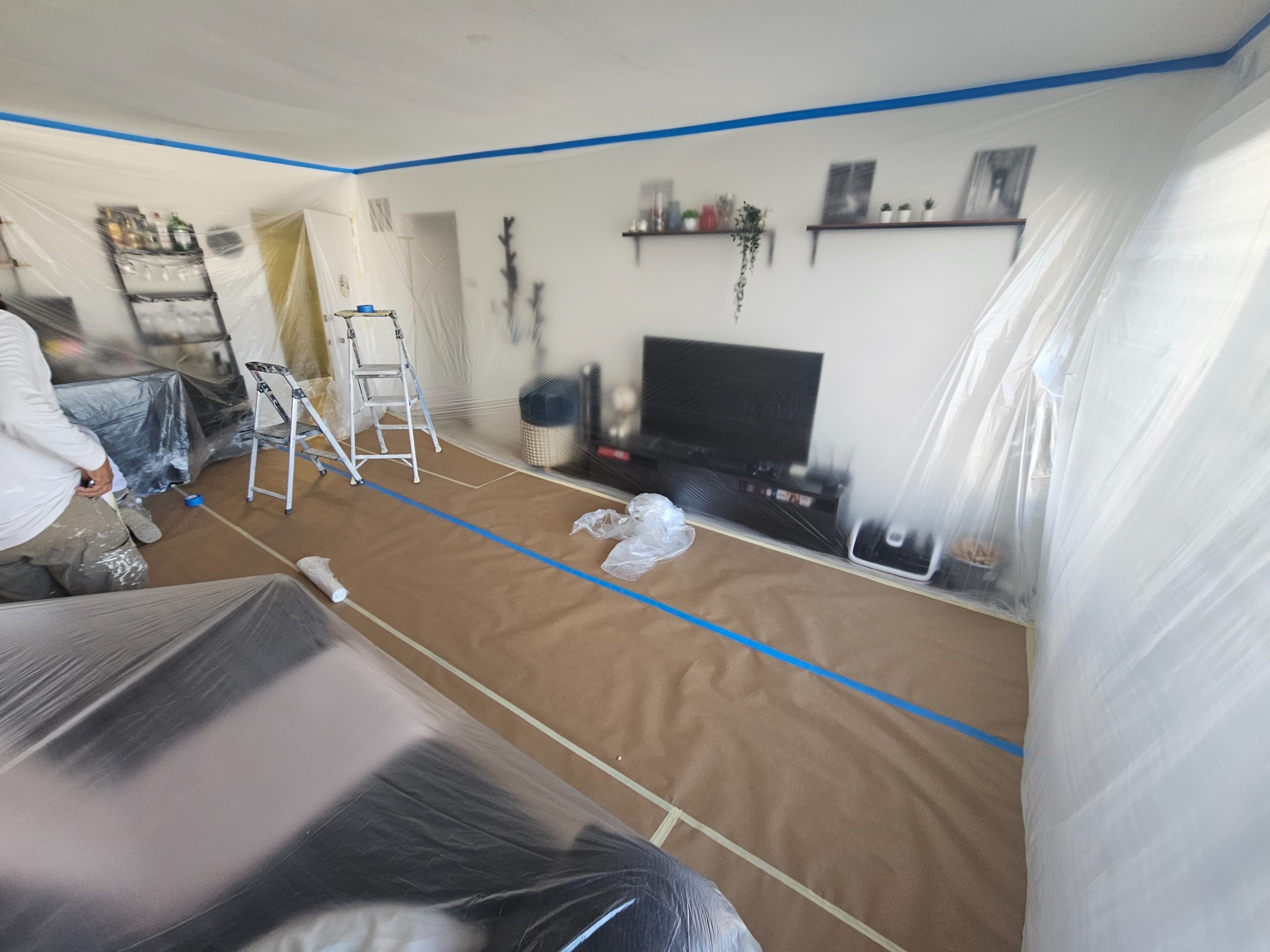 Occupied interior carefully protected before painting